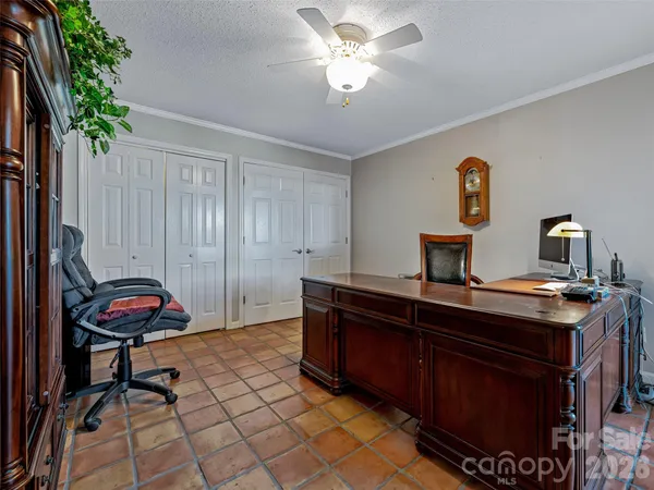 a view of a hallway to a livingroom with wooden floor and stairs
