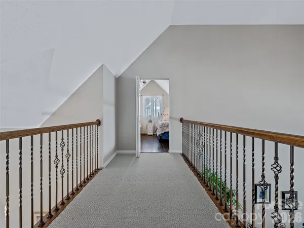 a bedroom with a bed a dresser and wooden floor