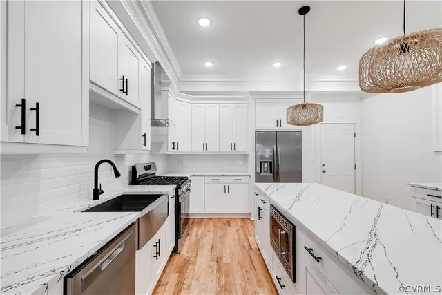 a kitchen with a sink a stove and cabinets