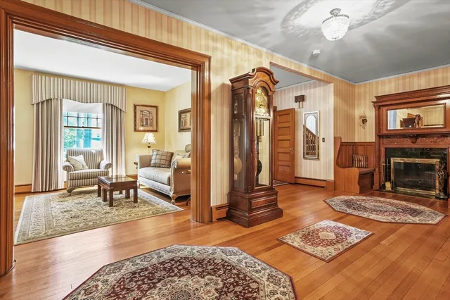 a living room with furniture a flat screen tv and a fireplace