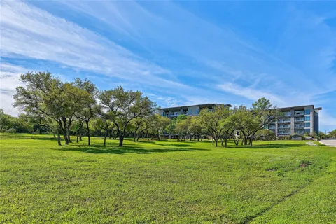 a view of a grassy field with benches