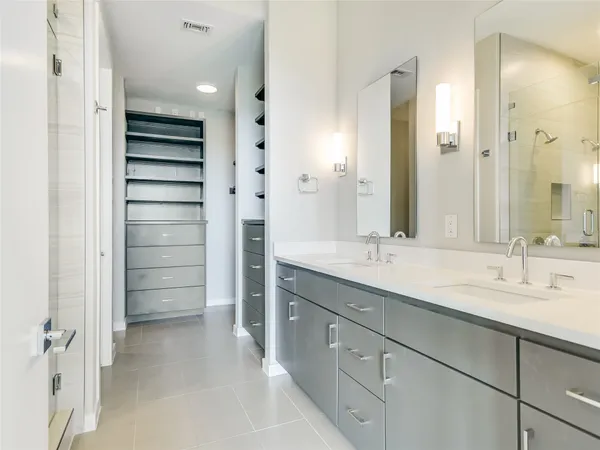 a bathroom with a shower sink and mirror