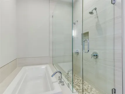 a bathroom with a bathtub and shower