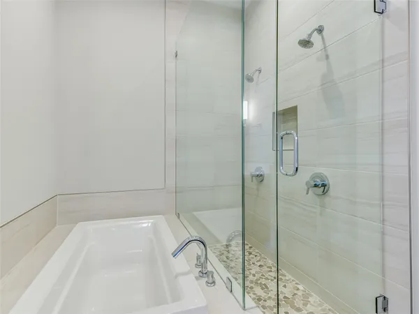a bathroom with a bathtub and shower