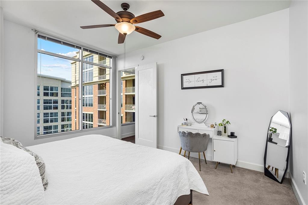 1820 Peachtree Road Northwest, Unit 1509 Atlanta, GA 30309 - Photo 23 of 61 a bedroom with a bed and a chandelier