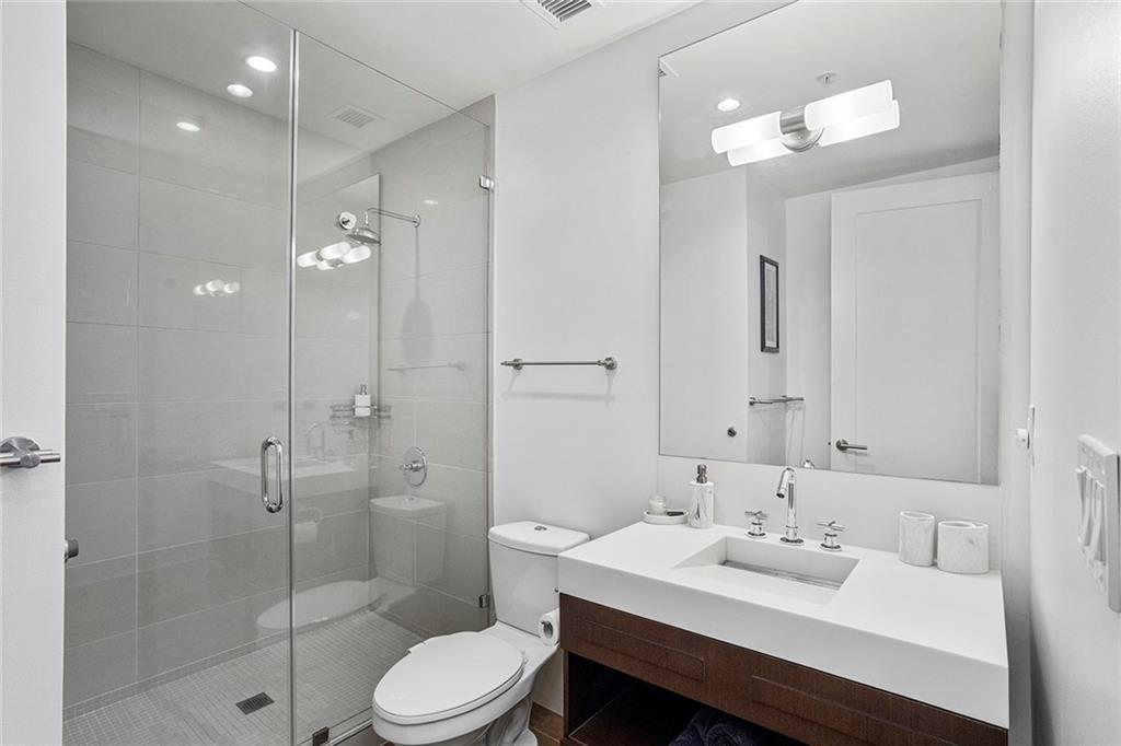 1820 Peachtree Road Northwest, Unit 1509 Atlanta, GA 30309 - Photo 37 of 61 a bathroom with a sink a toilet and shower