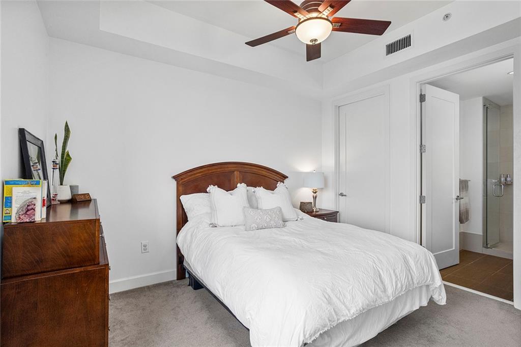 1820 Peachtree Road Northwest, Unit 1509 Atlanta, GA 30309 - Photo 38 of 61 a bedroom with a bed and a chandelier