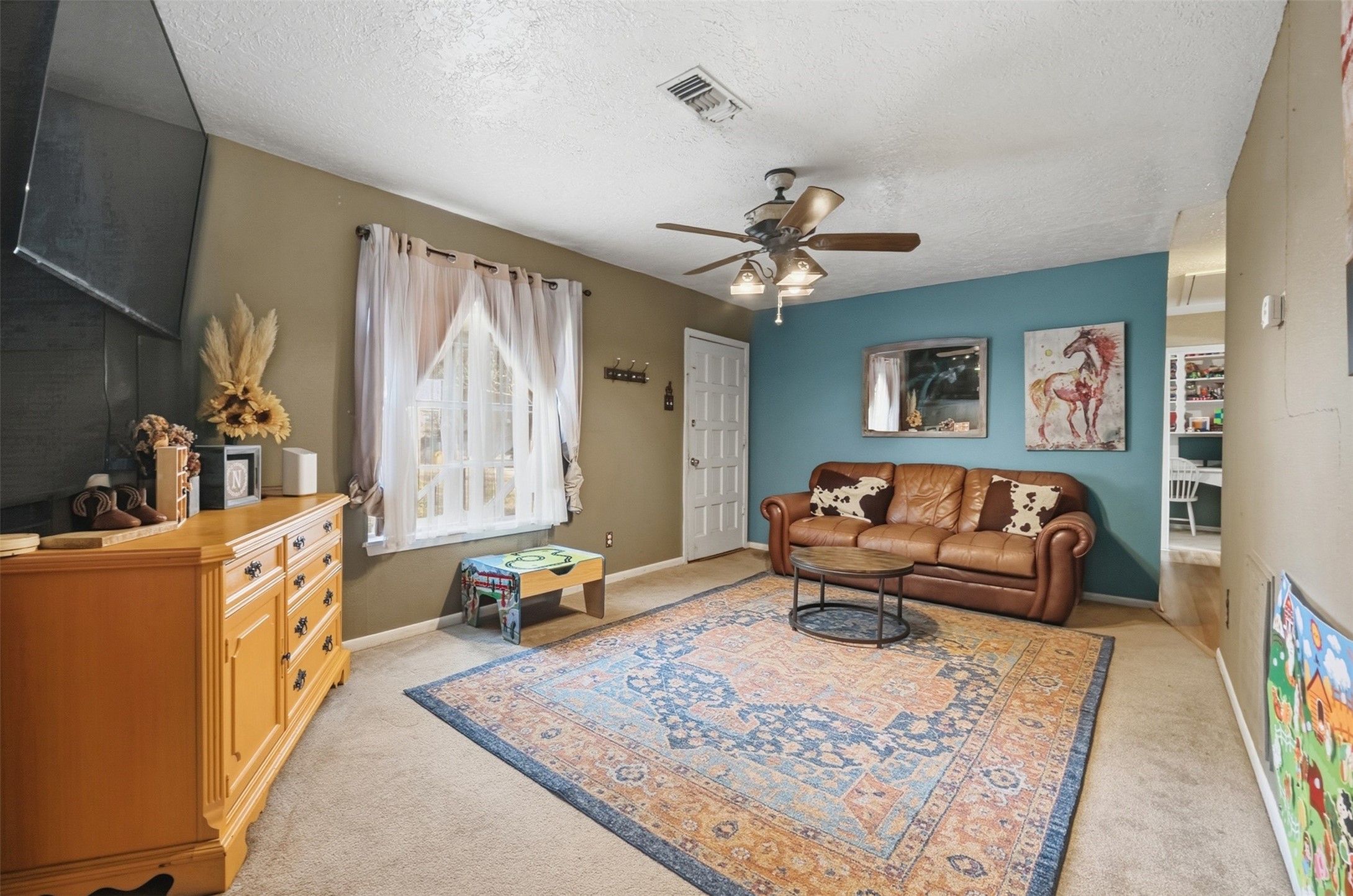 4027 Spring Branch Road Montgomery, TX 77316 - Photo 12 of 32 a living room with furniture and a chandelier