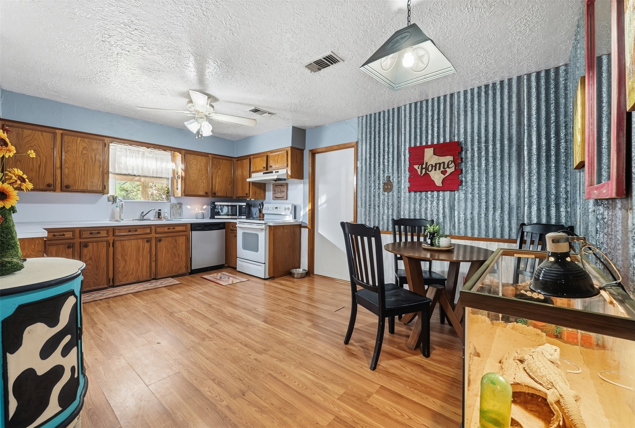 4027 Spring Branch Road Montgomery, TX 77316 - Photo 13 of 32 a kitchen with granite countertop cabinets a dining table and chairs