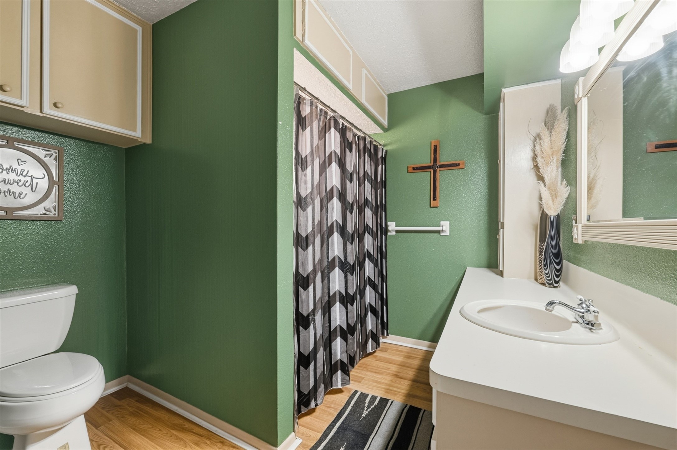 4027 Spring Branch Road Montgomery, TX 77316 - Photo 21 of 32 a bathroom with a sink a toilet and a mirror