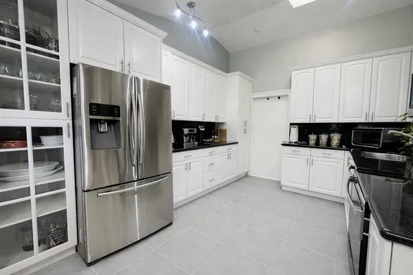 a kitchen with stainless steel appliances a refrigerator a stove a microwave and cabinets