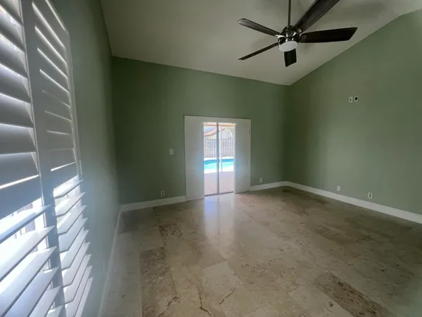 a bathroom with a granite countertop sink a mirror and a shower