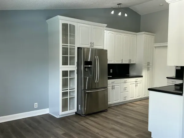 a kitchen with stainless steel appliances a refrigerator sink and microwave