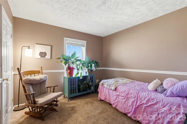 a bedroom with a bed and a chair