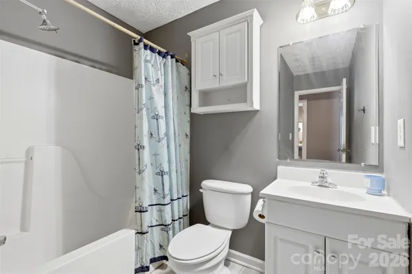 a white toilet sitting next to a bathroom sink