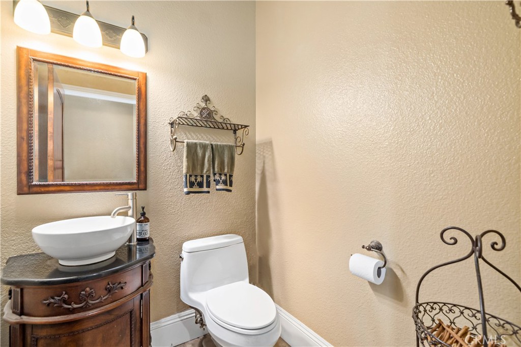 40430 Parado Del Sol Drive Temecula, CA 92592 - Photo 18 of 75 a bathroom with a toilet a sink and mirror