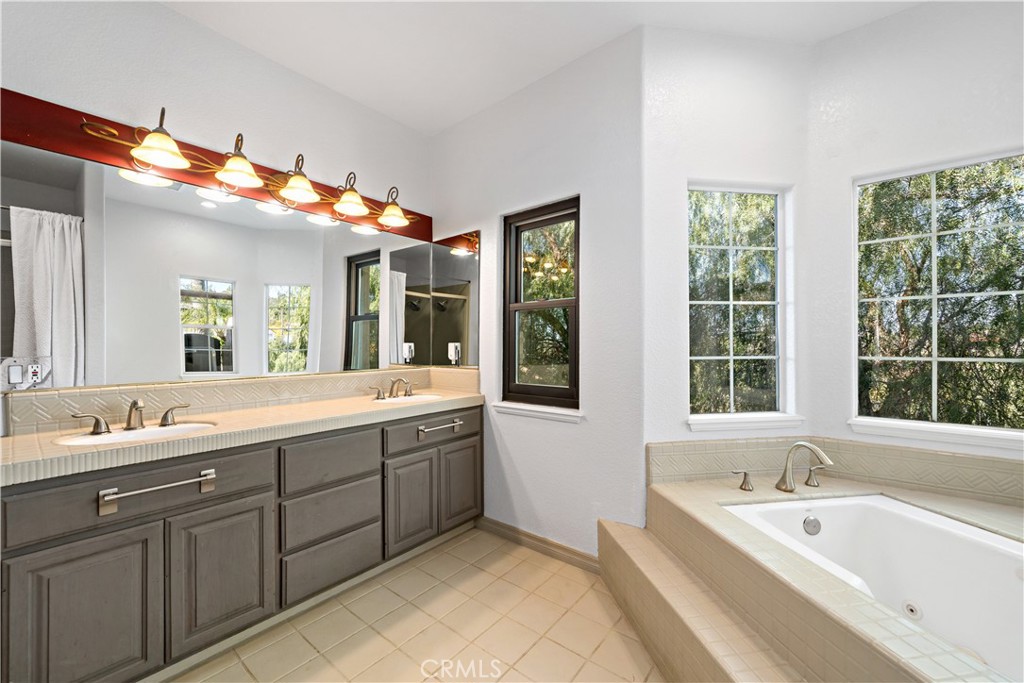 40430 Parado Del Sol Drive Temecula, CA 92592 - Photo 34 of 75 a spacious bathroom with a tub double sink and mirror