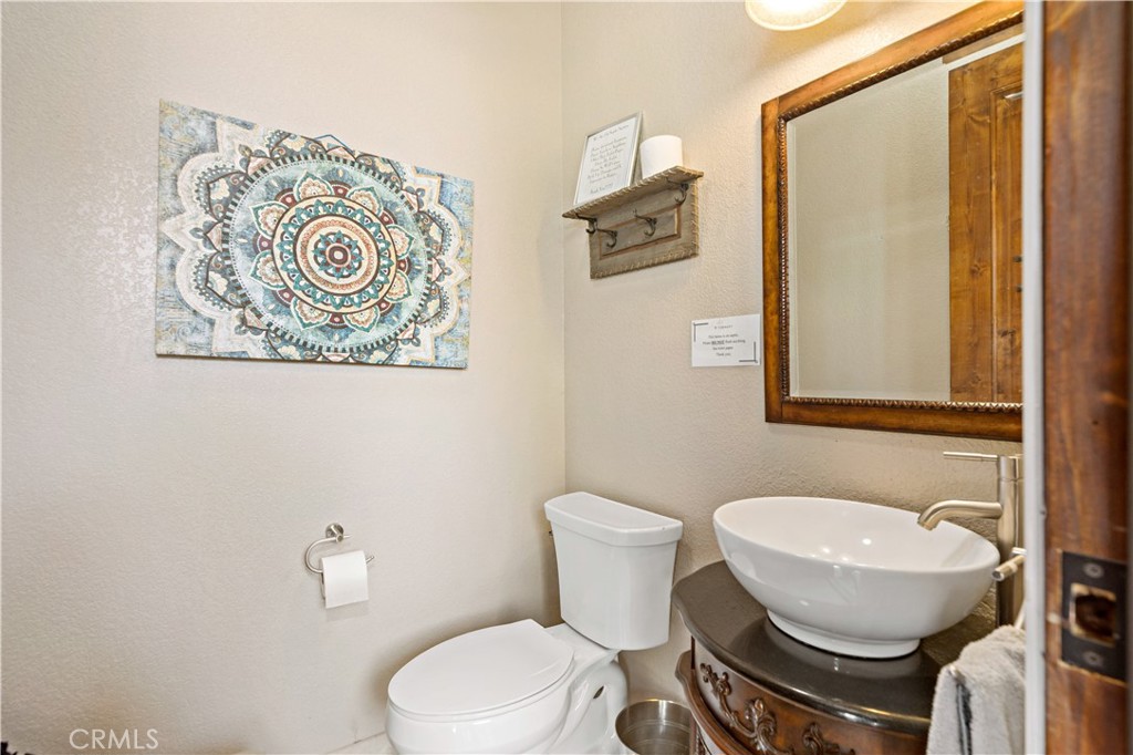 40430 Parado Del Sol Drive Temecula, CA 92592 - Photo 42 of 75 a bathroom with a toilet a sink and mirror