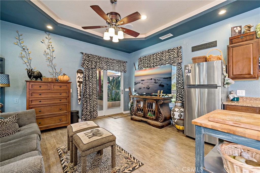 40430 Parado Del Sol Drive Temecula, CA 92592 - Photo 67 of 75 a living room with furniture a fireplace and a flat screen tv