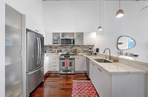 a kitchen with a sink appliances and cabinets