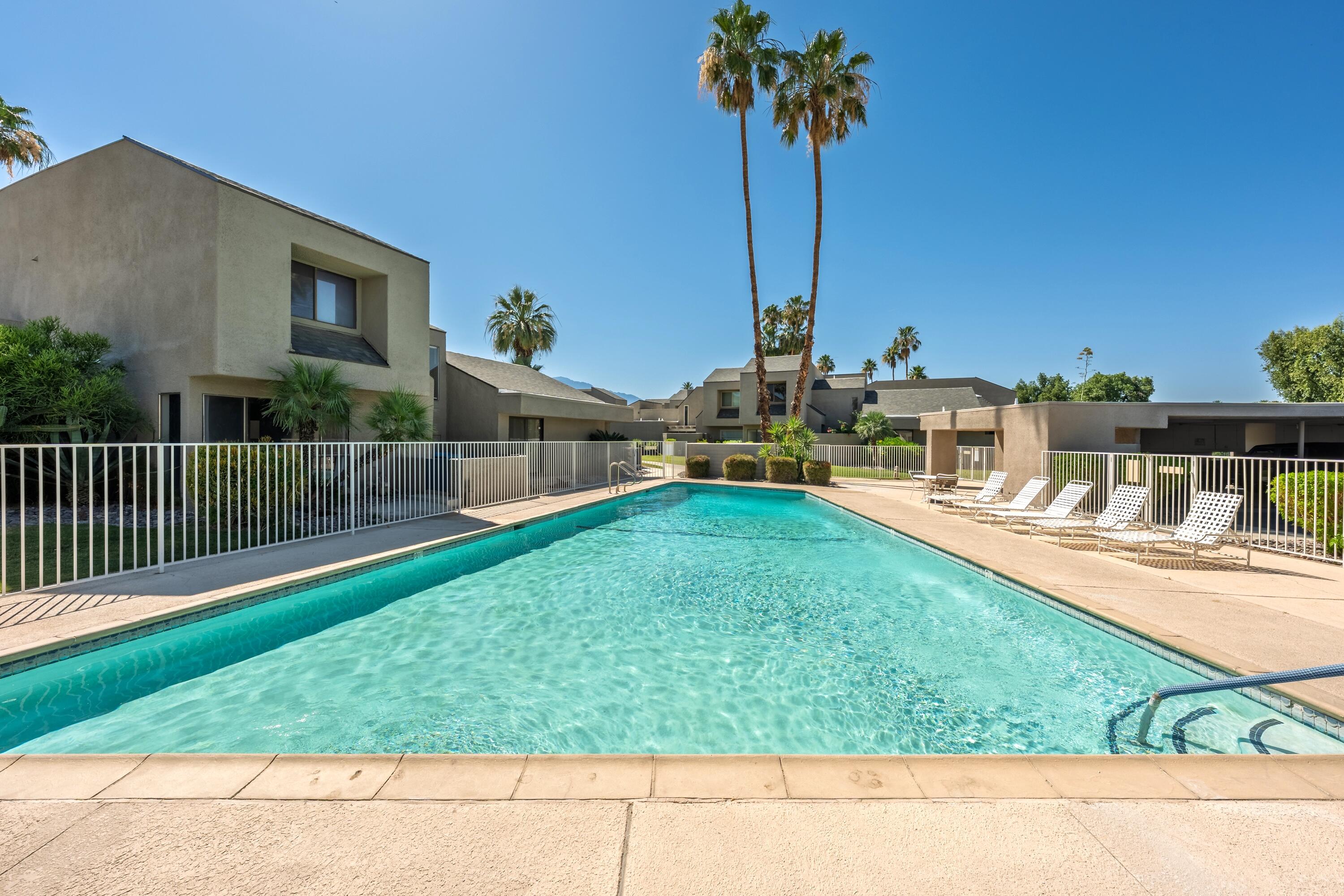 71870 Eleanora Lane Rancho Mirage, CA 92270 - Photo 30 of 36 a view of a house with a yard and a fence