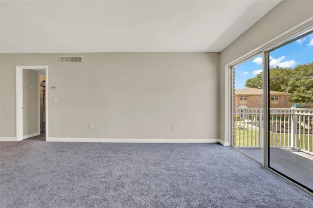 a view of an empty room and a window