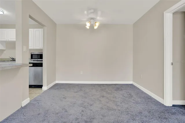 a bedroom with bed and a flat tv screen on the dresser