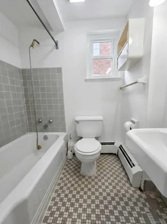 a bathroom with a toilet a sink and bathtub
