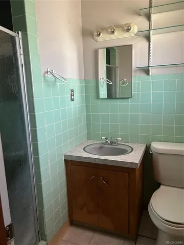 a bathroom with a sink toilet and mirror