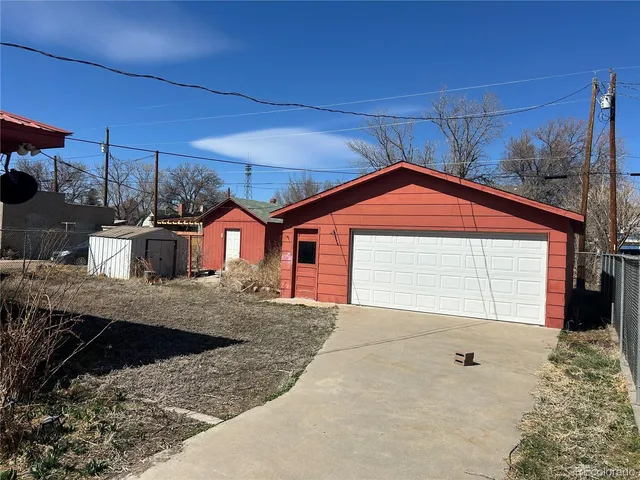 a view of a house with a small yard and sitting area