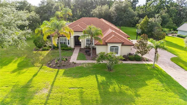 a front view of a house with yard and green space