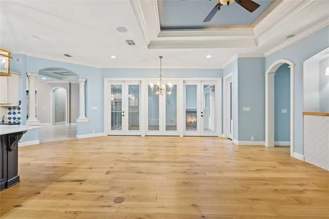 a kitchen with stainless steel appliances granite countertop a stove a sink dishwasher and a refrigerator with wooden floor