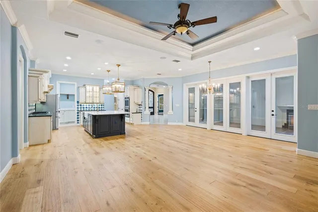 a kitchen with kitchen island granite countertop wooden cabinets and a sink