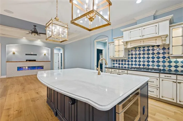 a spacious bathroom with a granite countertop sink and a tub