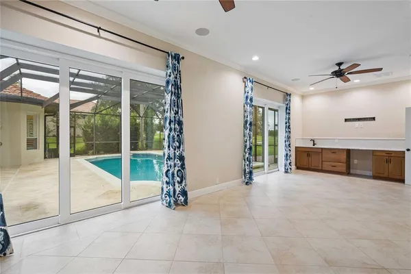 an empty room with floor to ceiling windows and yard