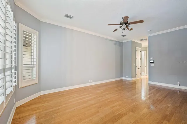 an empty room with floor to ceiling windows and yard