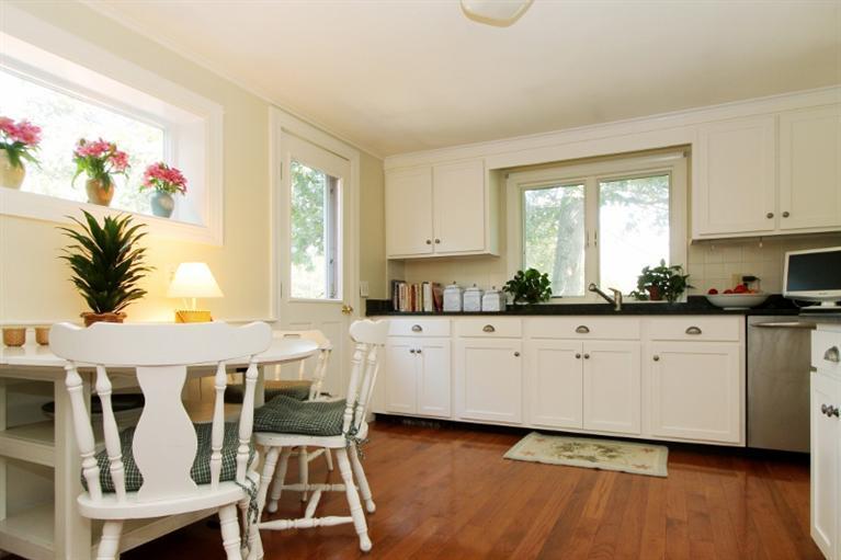 138 Long Road Harwich, MA 02645 - Photo 3 of 33 a kitchen with stainless steel appliances granite countertop a stove a sink and white cabinets with wooden floor