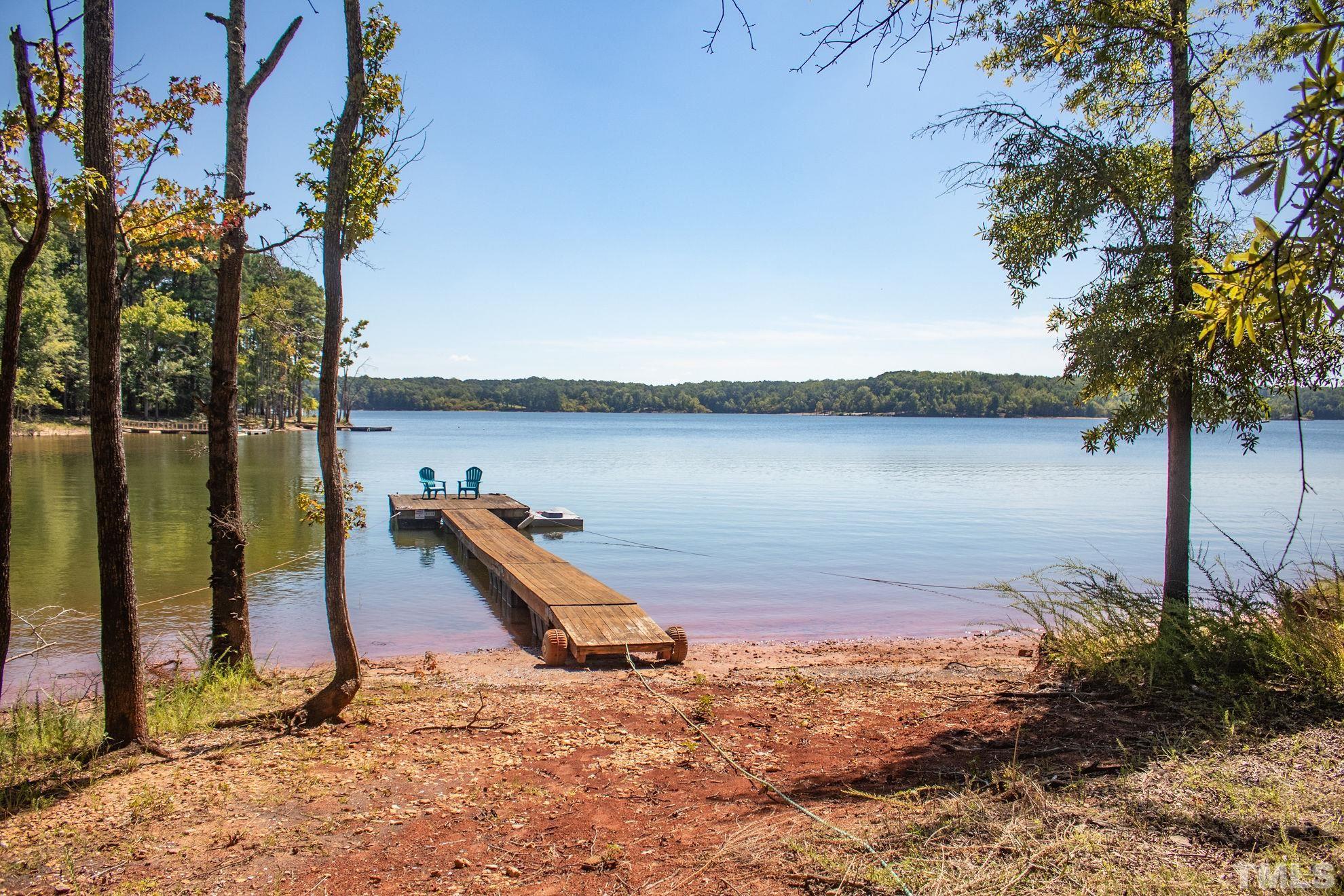 260 Waters Edge Loop Henderson, NC 27537 - Photo 11 of 38 a view of a lake with a tree
