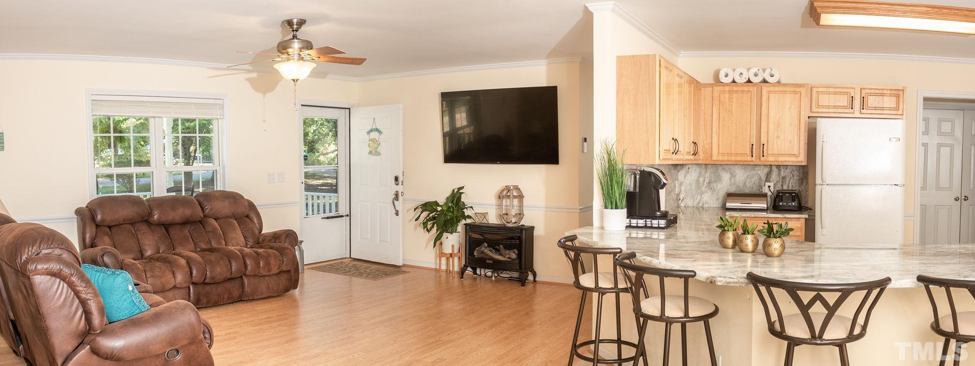 260 Waters Edge Loop Henderson, NC 27537 - Photo 12 of 38 a living room with furniture and a flat screen tv