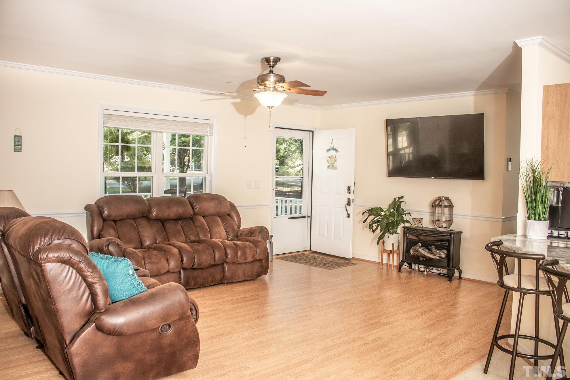 260 Waters Edge Loop Henderson, NC 27537 - Photo 13 of 38 a living room with furniture and a flat screen tv