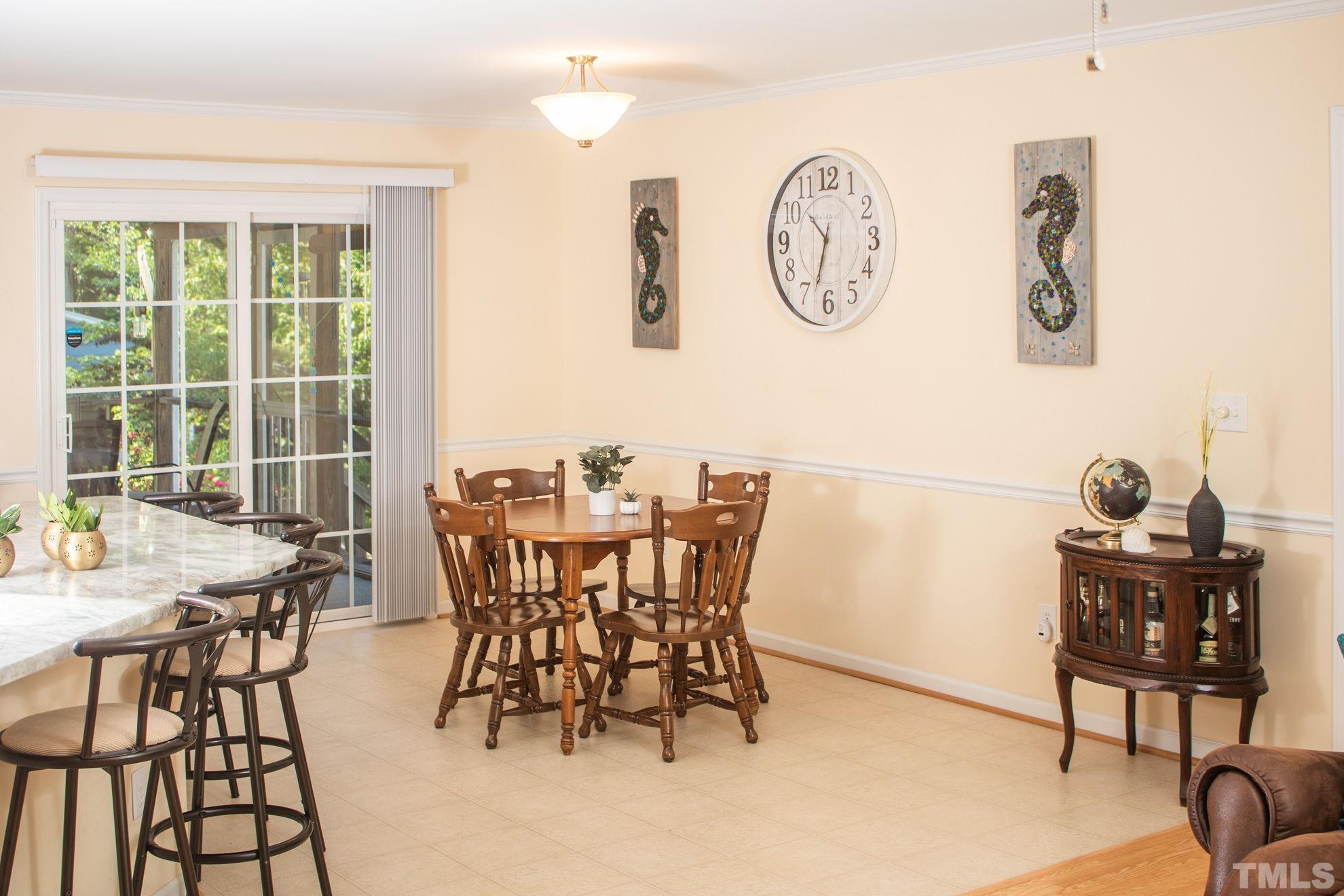 260 Waters Edge Loop Henderson, NC 27537 - Photo 18 of 38 a view of a dining room with furniture and wooden floor