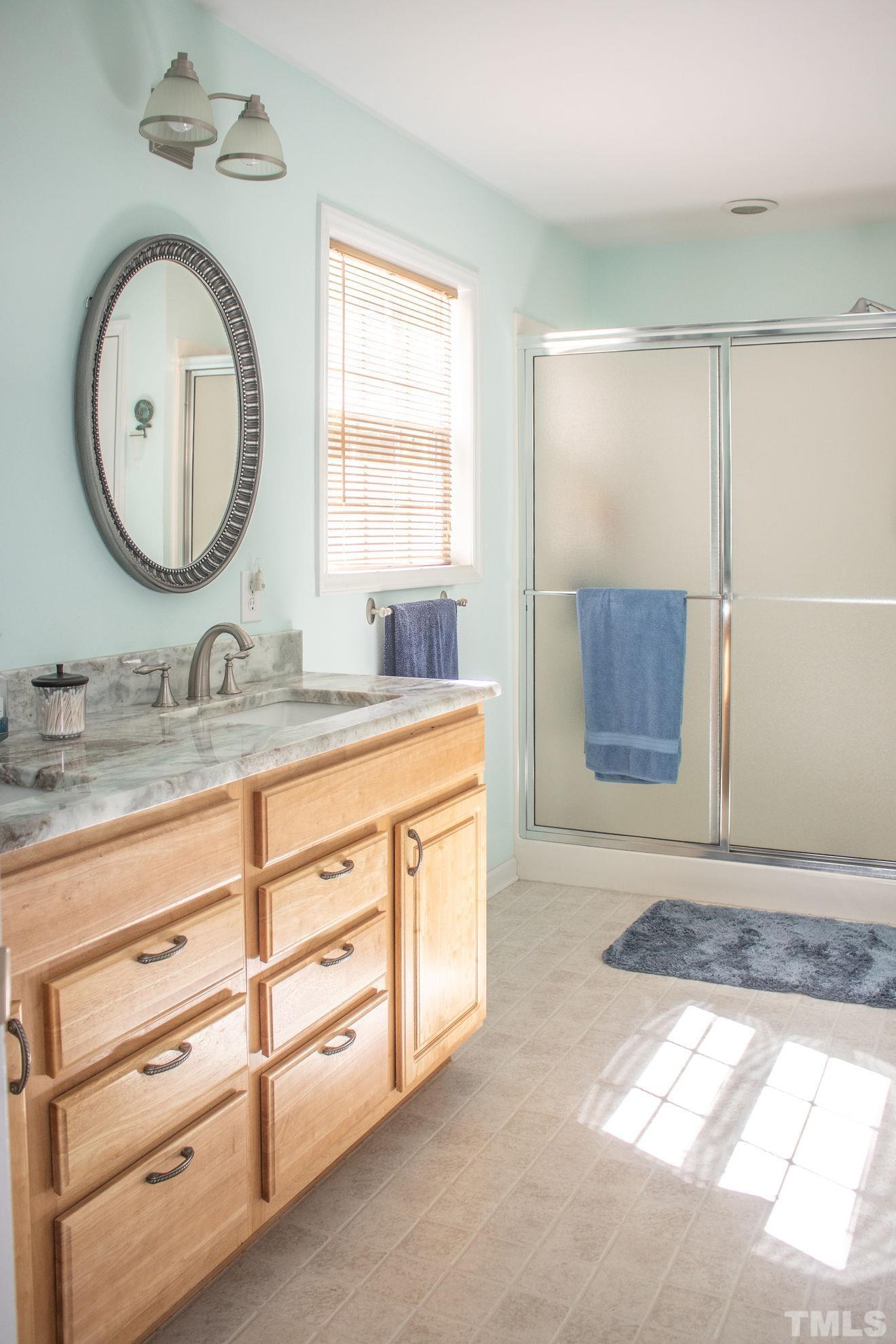 260 Waters Edge Loop Henderson, NC 27537 - Photo 20 of 38 a bathroom with a granite countertop sink a mirror and a