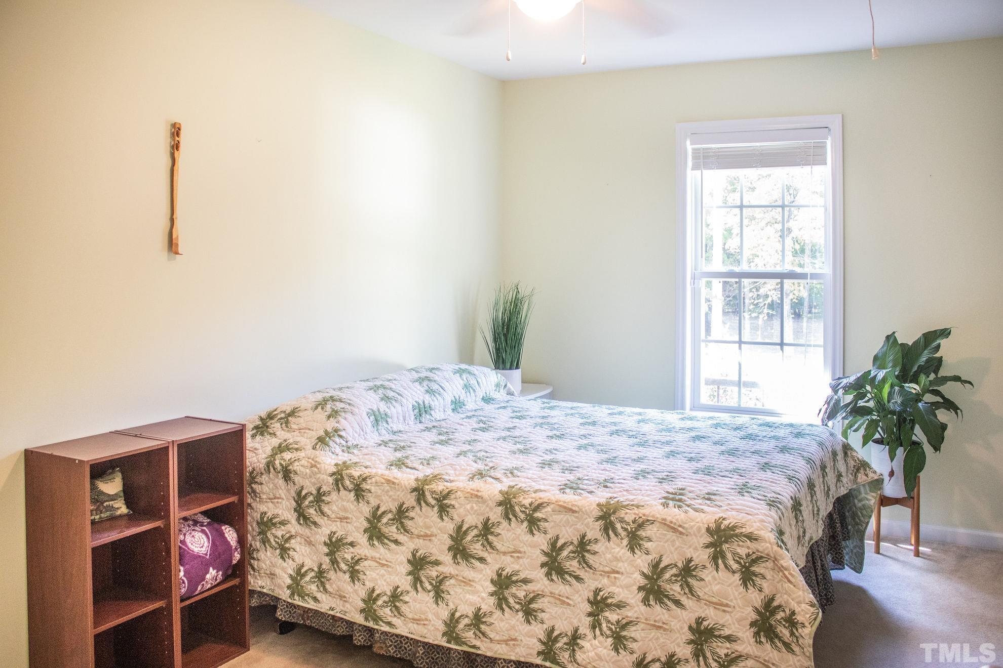 260 Waters Edge Loop Henderson, NC 27537 - Photo 21 of 38 a bedroom with a bed and a window