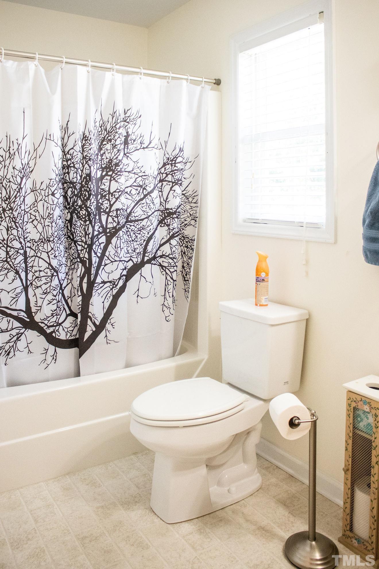 260 Waters Edge Loop Henderson, NC 27537 - Photo 25 of 38 a bathroom with a toilet sink and bathtub