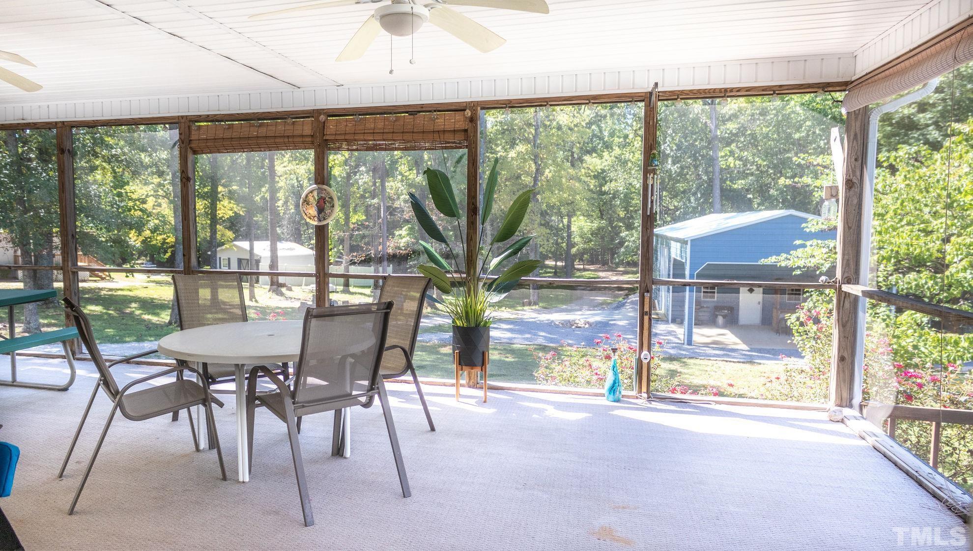 260 Waters Edge Loop Henderson, NC 27537 - Photo 27 of 38 a view of a city from a dining room with large windows