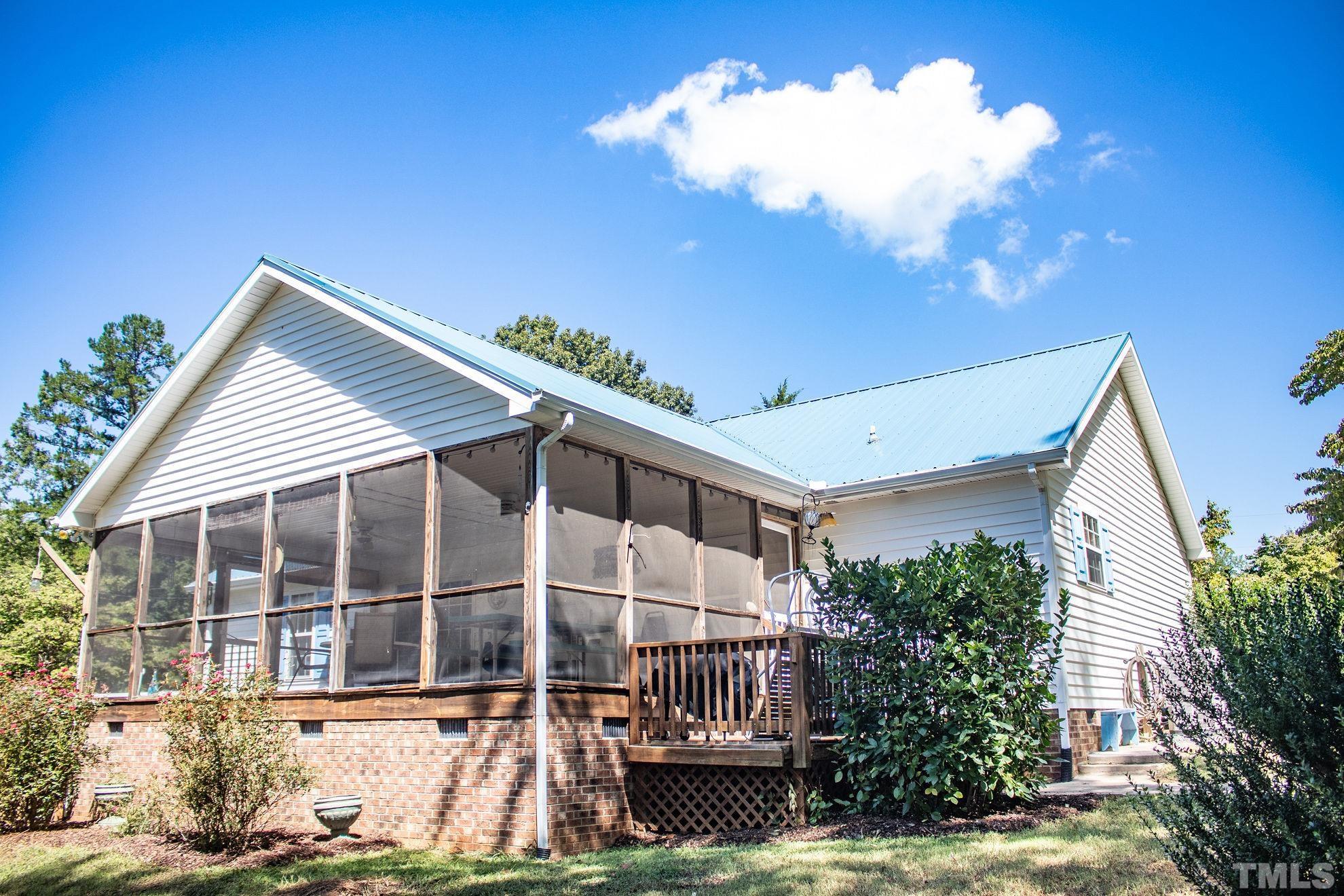 260 Waters Edge Loop Henderson, NC 27537 - Photo 28 of 38 a backyard of a house with table and chairs