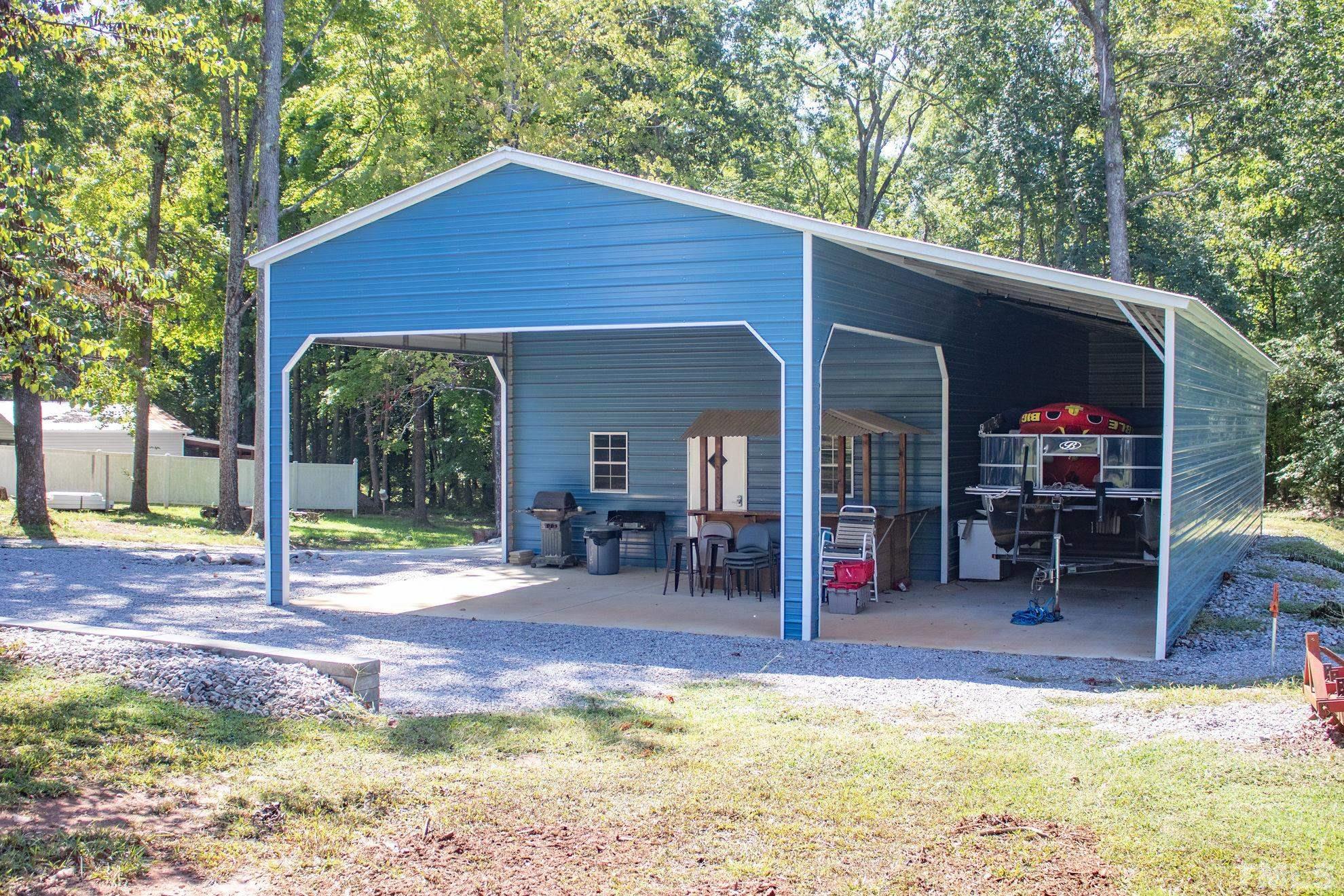 260 Waters Edge Loop Henderson, NC 27537 - Photo 33 of 38 a view of a house with backyard porch and sitting area