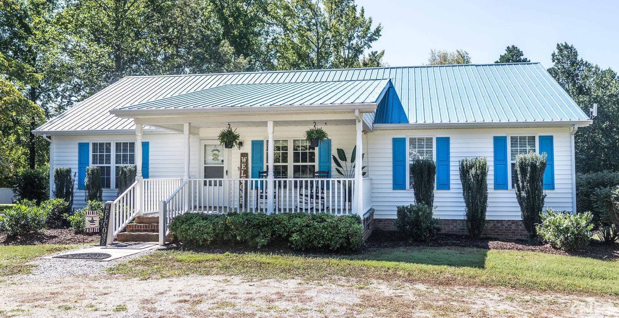 260 Waters Edge Loop Henderson, NC 27537 - Photo 5 of 38 a view of a house with a yard and plants