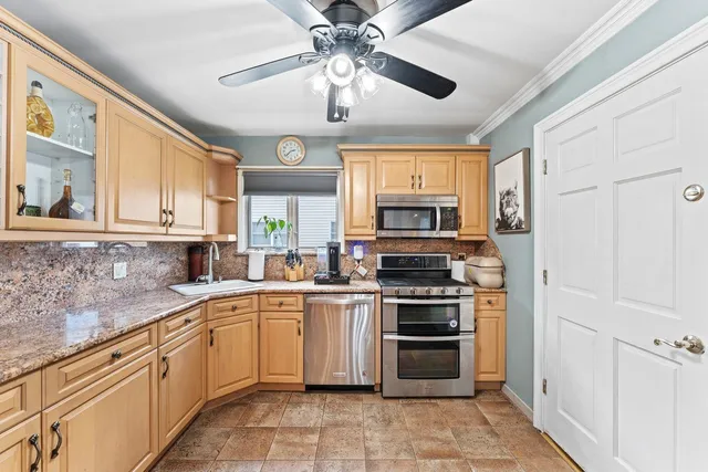 a kitchen with a stove sink and microwave