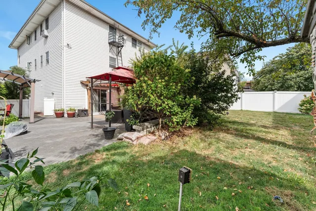 a view of a patio with a table and chairs under an umbrella